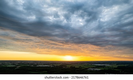 Aerial View Amazing Sunset Over Of The Suburbs With The City Under Dramatic Rain Cloud. Global Warming Effect Black Thunderstorm Dramatic Rain Clouds, Dramatic Sky, Shot By A Drone. High Quality Photo