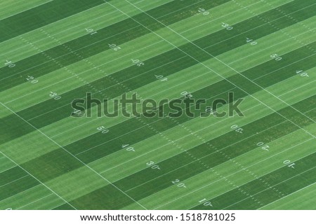 Aerial view of an american fotball empty field and its yard marks.
