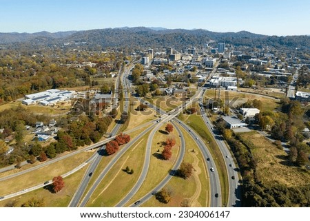 Aerial view of american freeway intersection in fall season in Asheville, North Carolina with fast moving cars and trucks. USA transportation infrastructure concept