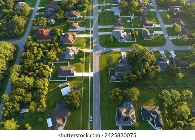 Aerial view of american small town in Florida with private homes between green palm trees and suburban streets in quiet residential area - Powered by Shutterstock