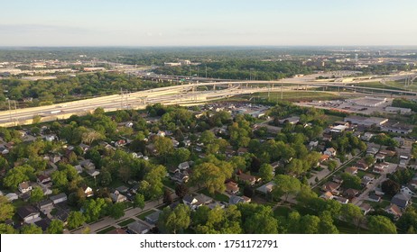 Aerial View Of American Suburb, Highway At Summertime.  Establishing Shot Of American Neighborhood. Real Estate, Residential Houses, Freeway, Traffic. Drone Shot, From Above