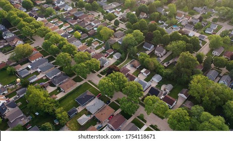  Aerial view of american suburb at summertime.  Establishing shot of american neighborhood. Real estate, residential houses. Drone shot, from above