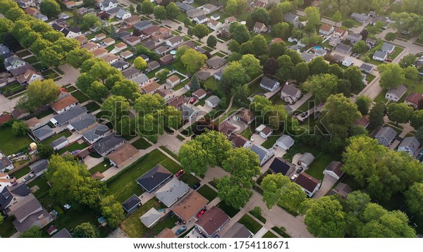  Aerial view of american suburb at summertime.\
 Establishing shot of american neighborhood. Real estate,\
residential houses. Drone shot, from\
above