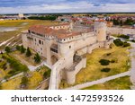 Aerial view of ancient Castle of Dukes of Alburquerque on background with Cuellar cityscape in summer day, Spain