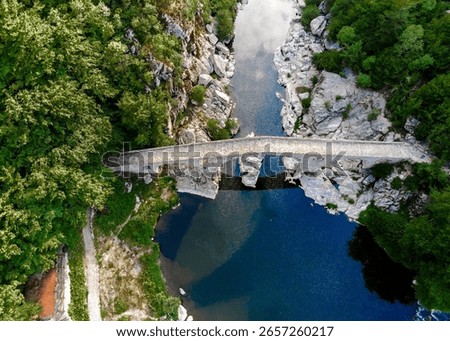 Aerial view of the ancient Devil's Bridge, a famous historic sixteenth-century arch bridge, across the Arda River in a narrow gorge, near the town of Ardino in the Rhodope Mountains, Bulgaria.