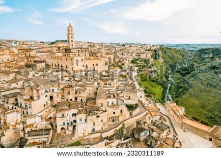 Aerial view of the ancient town of Matera (Sassi di Matera) in beautiful  Basilicata, southern Italy. ancient cave houses carved into the tufa rock over the deep ravine, gravina river