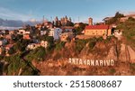 Aerial view of Antananarivo showcasing colorful buildings and historical landmarks at sunset