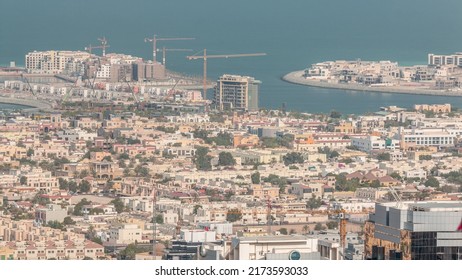 Aerial View Of Apartment Houses And Villas In Dubai City Timelapse From Skyscraper In Financial District, United Arab Emirates. Construction Site On Island