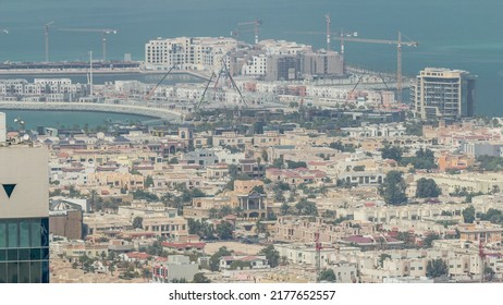 Aerial View Of Apartment Houses And Villas In Dubai City Timelapse From Skyscraper In Financial District, United Arab Emirates. Construction Site On Island