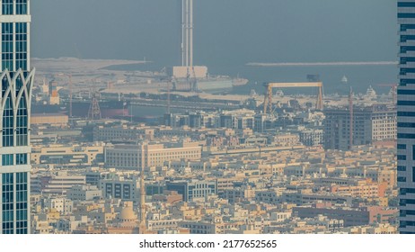 Aerial View Of Apartment Houses And Villas In Dubai City Timelapse From Skyscraper In Financial District, United Arab Emirates. Sea Port And Skyscraper Under Construction