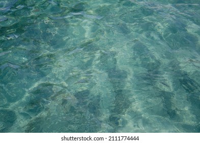 Aerial View Of Aquamarine Sea Surface. Rough Sea Texture. Top View Natural Background Of Rippled Sea-green Sea Water. Marine Theme With Copy Space.