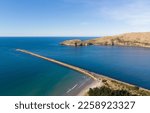 An aerial view of the Aramoana Mole and Taiaroa Head in Dunedin, New Zealand, the entrance of Otago Harbour, and the habitat of penguins and royal albatross, as well as many other birds.