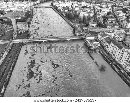 Aerial view of the Arno river during flood, Pisa, Italy.