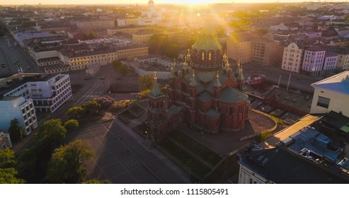 Aerial view around Uspetski cathedral and its golden cupoles, in the city of Helsinki, on a sunny summer evening dusk, in Helsingfors, Uusimaa, Finland