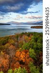 Aerial view of the Ashokan Reservoir at sunrise, capturing vibrant autumn foliage in shades of gold