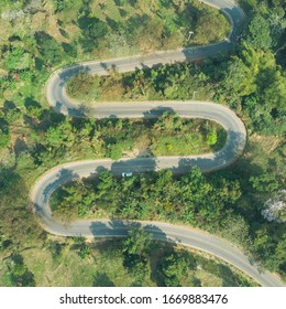 Aerial View Of Asphalt Winding Road In The Forest Mountain For Background.Scenic View Of Sharp Curve Road By Drone Safty Drive And Travel Concept.