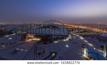 Aerial view of Aspire Zone from top night to day timelapse in Doha. Traffic on the road. Foggy weather