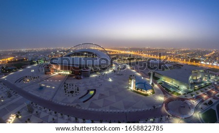 Aerial view of Aspire Zone from top night to day timelapse in Doha. Traffic on the road. Foggy weather
