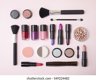 Aerial view of assorted make up and beauty products arranged on a pastel pink background - Shutterstock ID 549224482