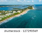 aerial view of atlantic ocean shoreline, intracoastal inlet and pier at boynton beach florida, with palm beach in the distance