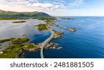 An aerial view of the Atlantic Road Bridge in Norway, showcasing its unique design winding across the islands and the breathtaking beauty of the Norwegian coastline.