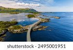 An aerial view of the Atlantic Road Bridge in Norway, a scenic bridge that winds its way through the islands and inlets of the Norwegian coast.