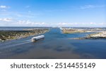 An aerial view of an autoliner cruising into port.