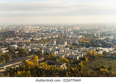 Aerial view of autumn morning in Warsaw. Grey buildings and trees with foggy blurred horizon line. Cloudy sky. Horizontal shot. High quality photo - Powered by Shutterstock