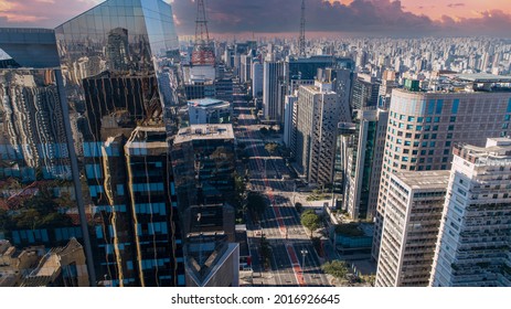 Aerial view of Av. Paulista in São Paulo, SP. Main avenue of the capital. Sunday day, without cars, with people walking on the street. Beautiful sunset
