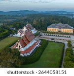 Aerial view of Baan Khan Temple in fog background. perspective showcasing a stunning Thai temple with intricate golden spires, surrounded by mist and rural landscapes under a beautiful sky.
