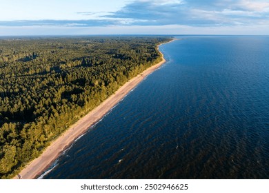 aerial view of the Baltic Sea coastline in Latvia, where dense forests meet the expansive blue waters and sandy beaches - Powered by Shutterstock