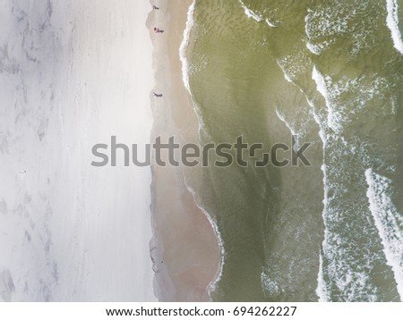 Similar – Luftaufnahme Panoramadrohne Blick auf den blauen Ozean Wellen, die am Sandstrand in Portugal erdrücken.