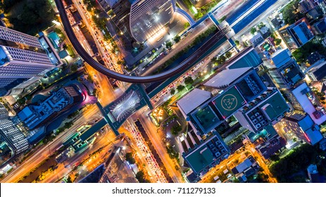 Aerial view of Bangkok buildings, Bangkok city downtown with sunset sky, Transaction beautiful road top view at night traffic