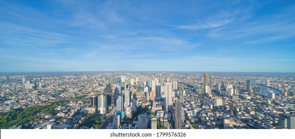 Aerial view of Bangkok Downtown Skyline. Thailand. Financial district and business centers in smart urban city in Asia. Skyscraper and high-rise buildings at noon with blue sky.