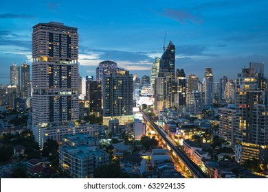 An aerial view of Bangkok metropolis skyscrapers and downtown area at dusk with sky train, corporate buildings, condomeniums, and malls. - Shutterstock ID 632924135