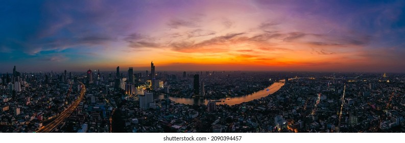 Aerial view of Bangkok skyline and skyscraper with light trails on Sirat Expy (toll road) center of the Chao Phraya River in Bangkok Thailand at sunset. - Powered by Shutterstock