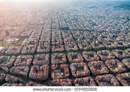 Aerial view of Barcelona cityscape with typical urban grid, Spain. Light leak effect applied
