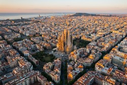 Aerial View Of Barcelona Eixample Residential District And Sagrada Familia Basilica At Sunrise. Catalonia, Spain. Cityscape With Typical Urban Octagon Blocks