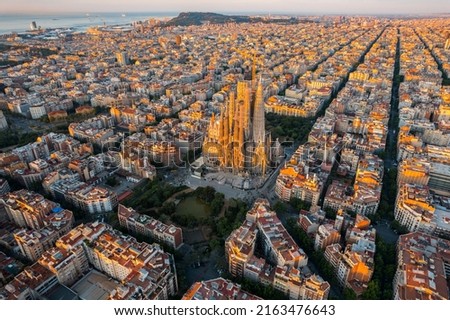 Aerial view of Barcelona Eixample residential district and Sagrada Familia Cathedral at sunrise. Catalonia, Spain