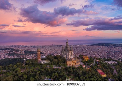 Aerial view of Barcelona skyline with Sagrat Cor temple during sunset, Catalonia, Spain