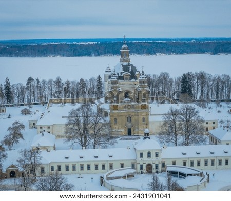 Aerial view of Baroque architecture Pazaislis monastery in Kaunas, Lithuania in winter with an icy Kaunas lagoon in background
