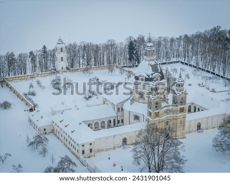 Aerial view of Baroque architecture Pazaislis monastery in Kaunas, Lithuania in winter with an icy Kaunas lagoon in background