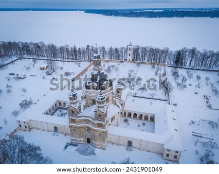 Aerial view of Baroque architecture Pazaislis monastery in Kaunas, Lithuania in winter with an icy Kaunas lagoon in background