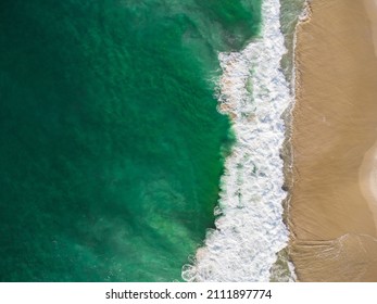 Aerial View Of Barra Da Tijuca Beach, A Paradise In The West Side Of Rio De Janeiro, Brazil. Greenish Sea Waves And Sand. Top View. Sunny Day At Dawn. Drone Photo.