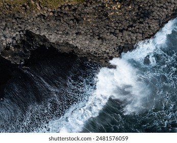 Aerial view of basalt columns and crashing waves at Reynisfjara black sand beach, Iceland. - Powered by Shutterstock