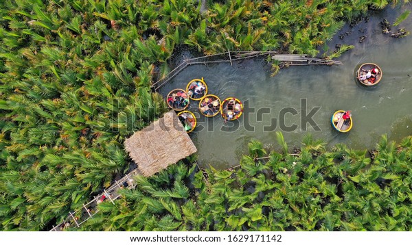 Aerial view a basket boat tour at the\
coconut water ( mangrove palm ) forest in Cam Thanh village, Hoi\
An, Bamboo Basket Boats Near Hoi An Ancient\
Town.