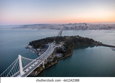 An aerial view of the Bay Bridge and Treasure Island with the City of San Francisco in the background.