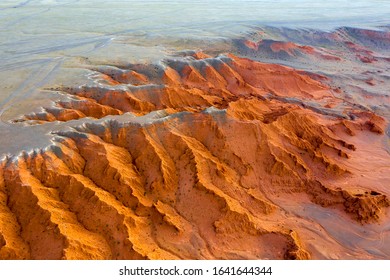 Aerial view of the Bayanzag flaming cliffs at sunset in Mongolia, found in the Gobi Desert