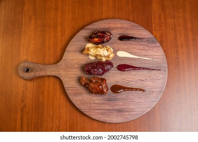 Aerial View Of BBQ Wings On Table And Wooden Table. Casual Photo Of Fast Food In Overhead View.