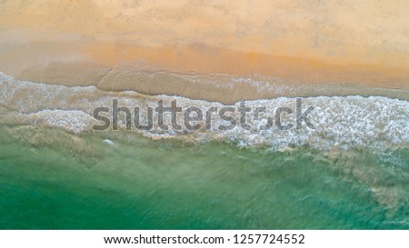 Similar – Luftpanorama-Drohne Blick auf die Meereswellen, die am felsigen Strand erdrücken.